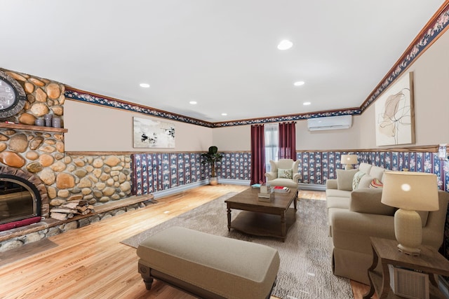 99 Stone Ln, Levittown, NY 11756 - living area featuring a wall unit AC, wood finished floors, recessed lighting, a fireplace, and wainscoting