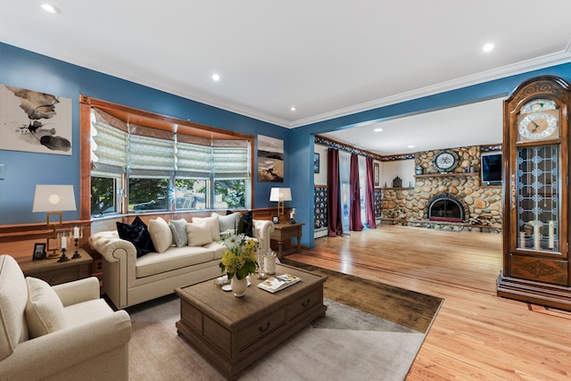 99 Stone Ln, Levittown, NY 11756 - living area featuring ornamental molding, wood finished floors, a stone fireplace, recessed lighting, and a wainscoted wall