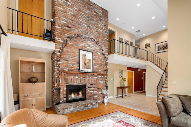 35 David Rd, Somers, NY 10589 - living area with a towering ceiling, stairs, a fireplace, wood finished floors, and recessed lighting