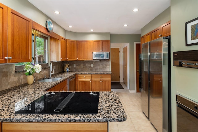 35 David Rd, Somers, NY 10589 - kitchen featuring stainless steel appliances, tasteful backsplash, brown cabinetry, light tile patterned floors, and recessed lighting