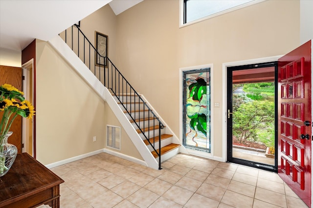 35 David Rd, Somers, NY 10589 - foyer featuring healthy amount of natural light, stairs, light tile patterned floors, and a high ceiling