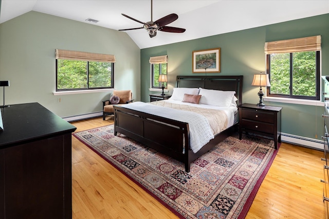 35 David Rd, Somers, NY 10589 - bedroom with vaulted ceiling, a baseboard radiator, multiple windows, and light wood-style floors