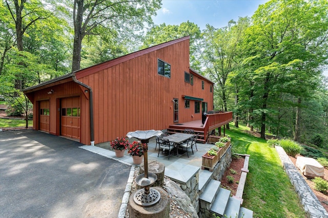35 David Rd, Somers, NY 10589 - view of side of home with a detached garage, a wooden deck, a patio area, and outdoor dining space