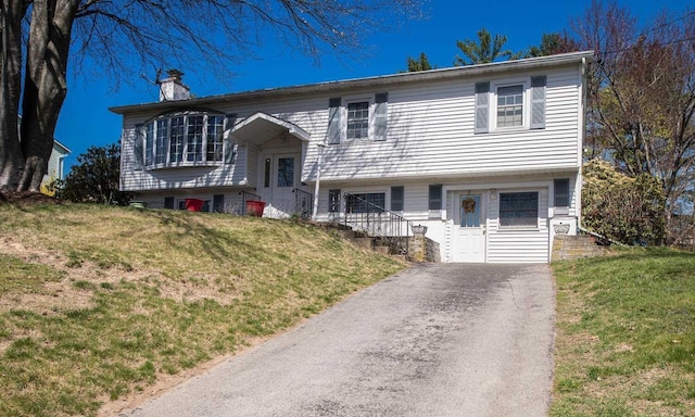 12 Dwyer Ln, Wappingers Falls, NY 12590 - raised ranch featuring a chimney and a front lawn