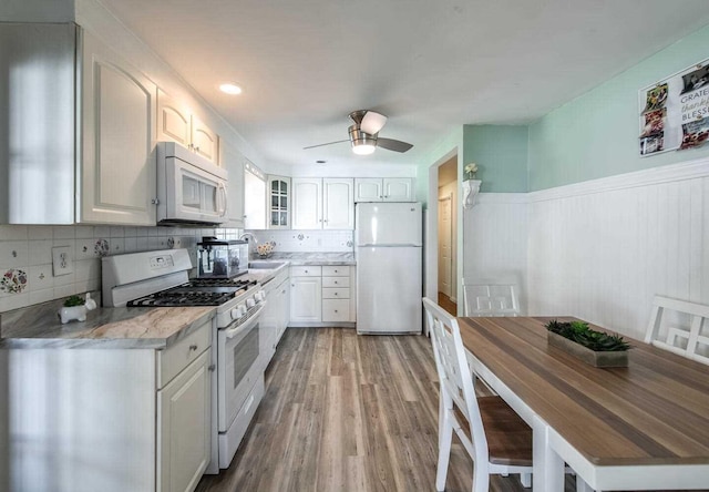 12 Dwyer Ln, Wappingers Falls, NY 12590 - kitchen featuring white appliances, glass insert cabinets, light wood-style floors, white cabinetry, and a ceiling fan