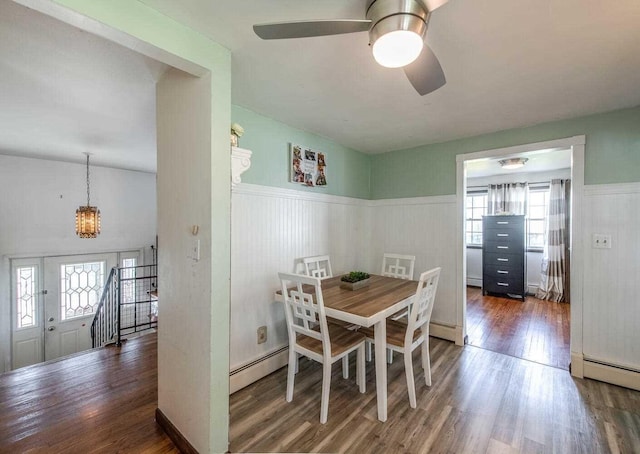 12 Dwyer Ln, Wappingers Falls, NY 12590 - dining room with a baseboard radiator, wood finished floors, a wainscoted wall, a chandelier, and a ceiling fan