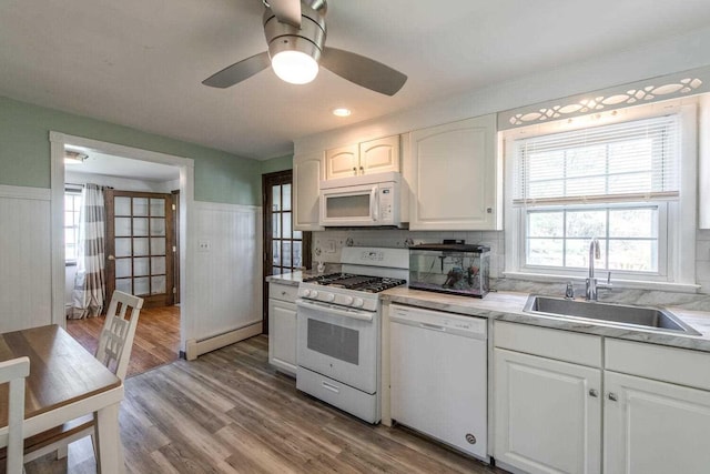 12 Dwyer Ln, Wappingers Falls, NY 12590 - kitchen featuring white appliances, a wainscoted wall, white cabinets, light countertops, and ceiling fan