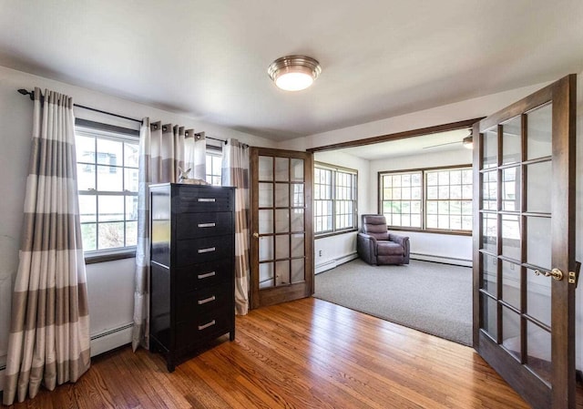 12 Dwyer Ln, Wappingers Falls, NY 12590 - office with french doors, a baseboard radiator, a baseboard heating unit, and wood finished floors