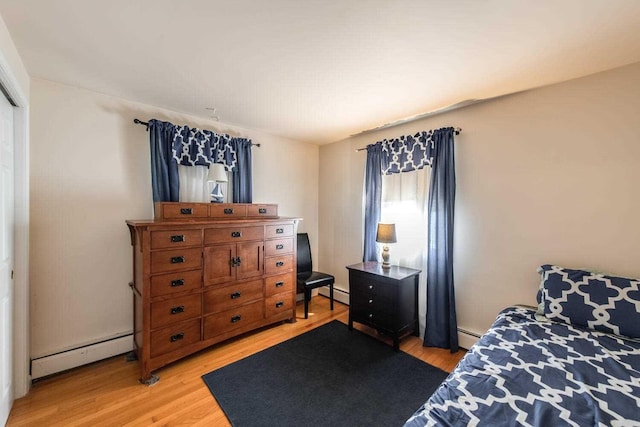 12 Dwyer Ln, Wappingers Falls, NY 12590 - bedroom with a baseboard heating unit and light wood-style flooring