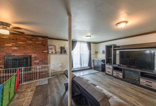 12 Dwyer Ln, Wappingers Falls, NY 12590 - living room with crown molding, ceiling fan, wood finished floors, and a brick fireplace