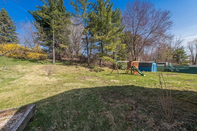 12 Dwyer Ln, Wappingers Falls, NY 12590 - view of grassy yard featuring a playground and a storage unit