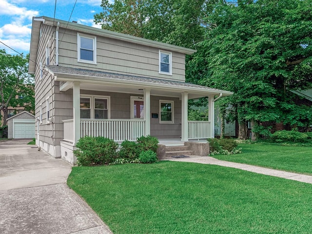 20 Fairmount Blvd, Garden City, NY 11530 - view of front of home with covered porch, an outbuilding, a front lawn, roof with shingles, and a garage