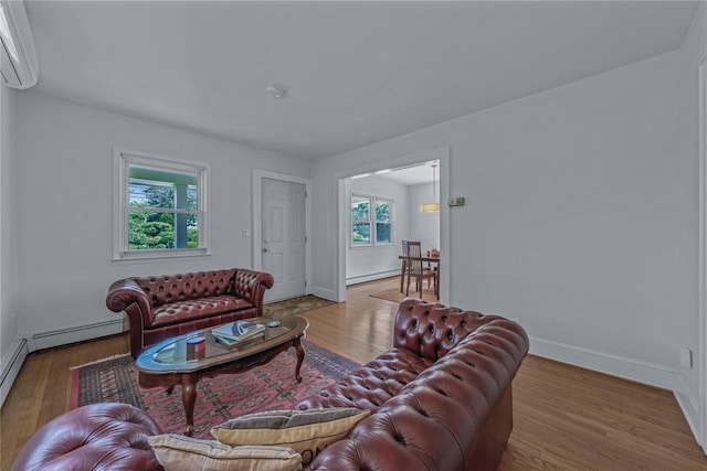 20 Fairmount Blvd, Garden City, NY 11530 - living room with an AC wall unit, wood finished floors, and baseboard heating