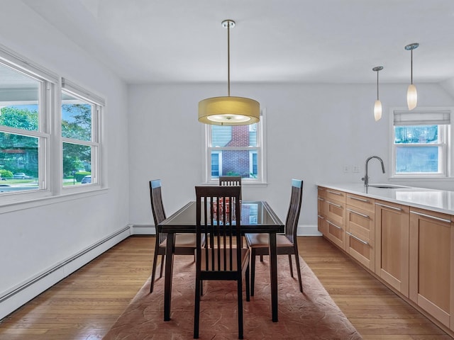 20 Fairmount Blvd, Garden City, NY 11530 - dining area featuring a baseboard heating unit and light wood-style flooring