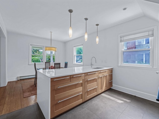 20 Fairmount Blvd, Garden City, NY 11530 - kitchen with baseboard heating, a peninsula, light countertops, pendant lighting, and dark tile patterned flooring