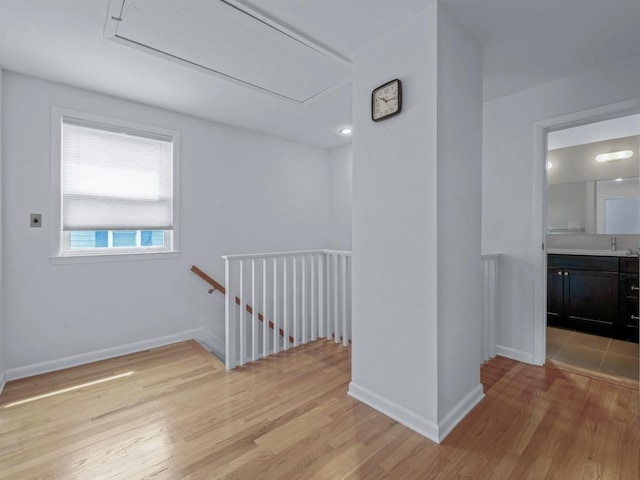 20 Fairmount Blvd, Garden City, NY 11530 - corridor with attic access, an upstairs landing, and light wood-type flooring