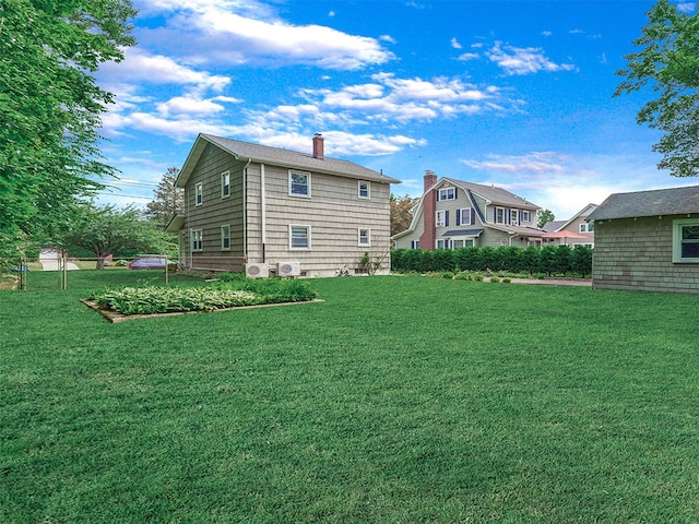 20 Fairmount Blvd, Garden City, NY 11530 - back of house with a lawn and a chimney