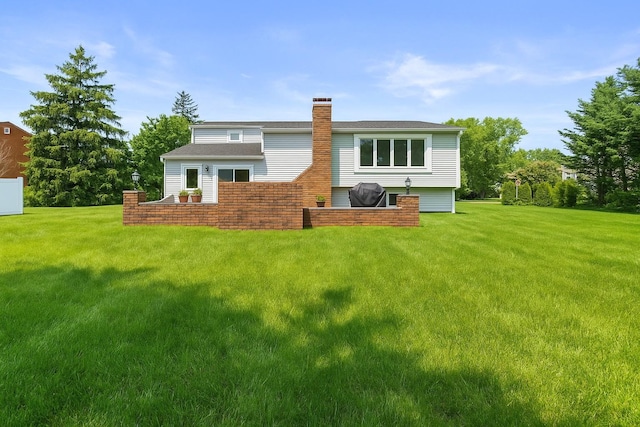 61 Sherwood Ct, Huntington, NY 11743 - rear view of house featuring a chimney and a yard