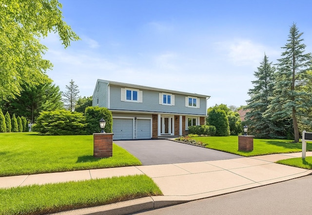 61 Sherwood Ct, Huntington, NY 11743 - view of front of house with driveway, a front yard, a garage, and brick siding