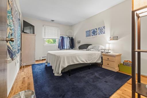 61 Sherwood Ct, Huntington, NY 11743 - bedroom with wood finished floors and a baseboard radiator