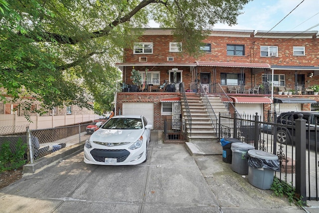 2328 Ellis Ave, Bronx, NY 10462 - view of property with a garage, brick siding, stairs, and concrete driveway
