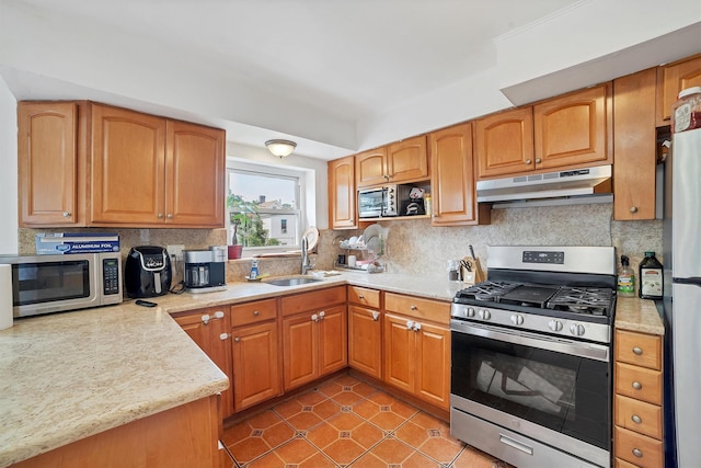 2328 Ellis Ave, Bronx, NY 10462 - kitchen featuring stainless steel appliances, under cabinet range hood, backsplash, light tile patterned floors, and light stone counters