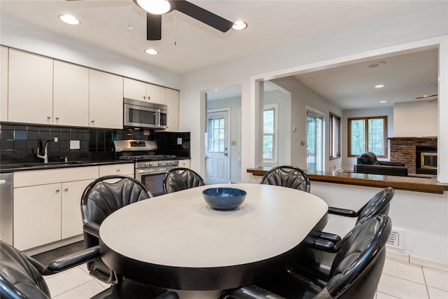 9 Westlyn Dr, Bardonia, NY 10954 - dining area featuring a ceiling fan, light tile patterned floors, recessed lighting, and a brick fireplace