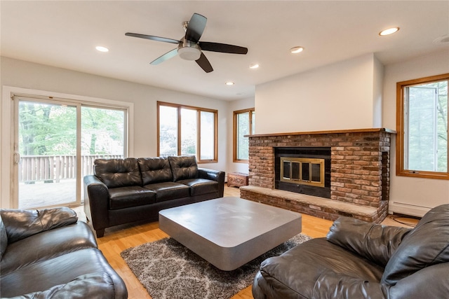9 Westlyn Dr, Bardonia, NY 10954 - living room with light wood-type flooring, recessed lighting, a baseboard heating unit, a ceiling fan, and a fireplace