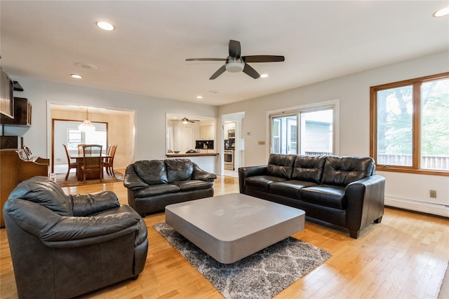 9 Westlyn Dr, Bardonia, NY 10954 - living room with a baseboard heating unit, a ceiling fan, light wood-style floors, plenty of natural light, and recessed lighting
