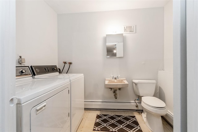 9 Westlyn Dr, Bardonia, NY 10954 - bathroom with a baseboard heating unit and washer and clothes dryer
