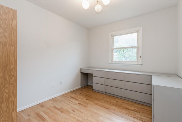 9 Westlyn Dr, Bardonia, NY 10954 - unfurnished bedroom with light wood finished floors and built in desk