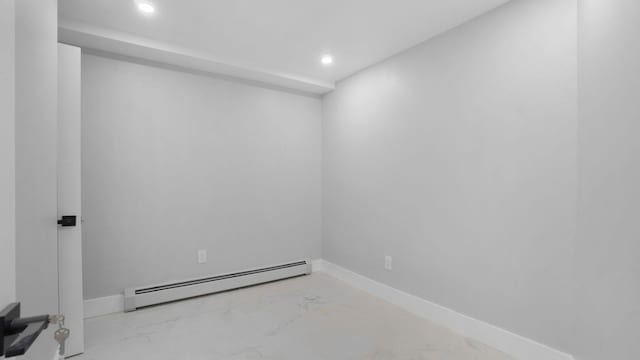 506 E 183rd St, Bronx, NY 10458 - empty room with a baseboard heating unit, recessed lighting, and marble look tiles