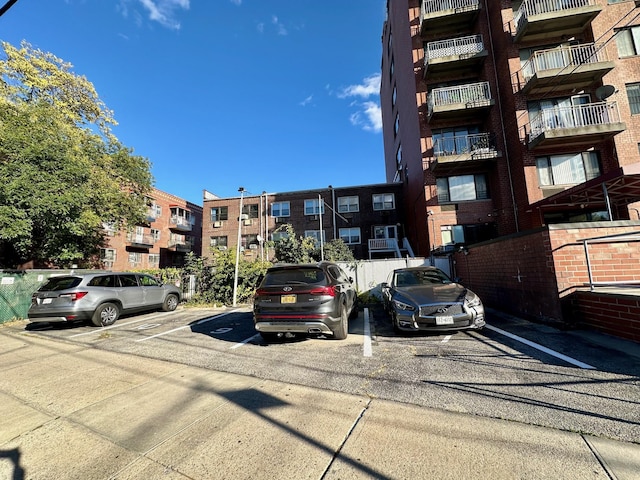 87-14 57th Rd Unit 1A, Elmhurst, NY 11373 - view of apartment building / complex featuring uncovered parking