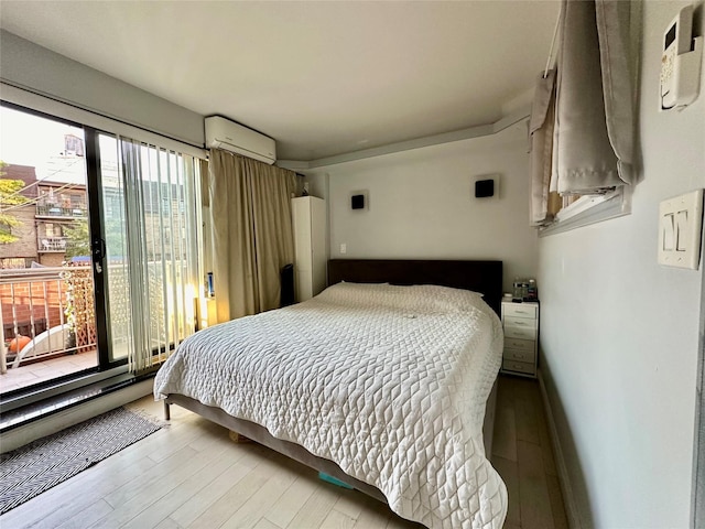 87-14 57th Rd Unit 1A, Elmhurst, NY 11373 - bedroom featuring a wall mounted AC and wood finished floors