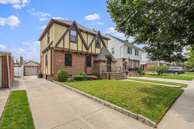 163-50 25th Dr, Flushing, NY 11358 - tudor house featuring an outbuilding, brick siding, driveway, stucco siding, and a front yard