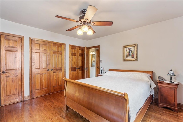 163-50 25th Dr, Flushing, NY 11358 - bedroom with multiple closets, wood finished floors, and a ceiling fan