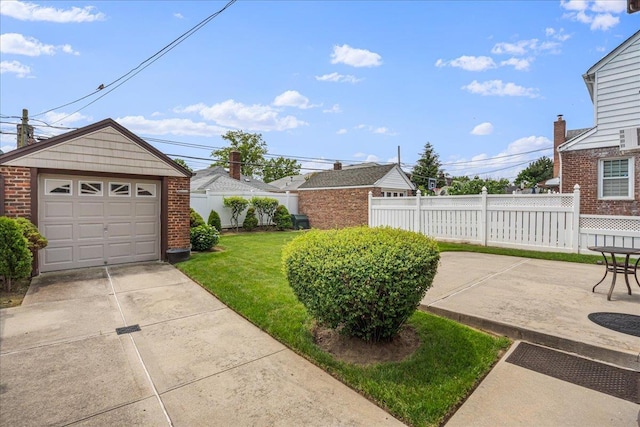 163-50 25th Dr, Flushing, NY 11358 - view of yard featuring a detached garage, concrete driveway, and an outbuilding