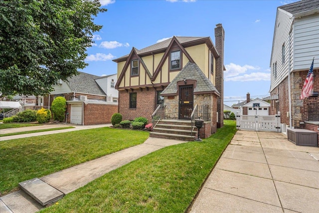 163-50 25th Dr, Flushing, NY 11358 - tudor home featuring a gate, stucco siding, a chimney, stone siding, and brick siding