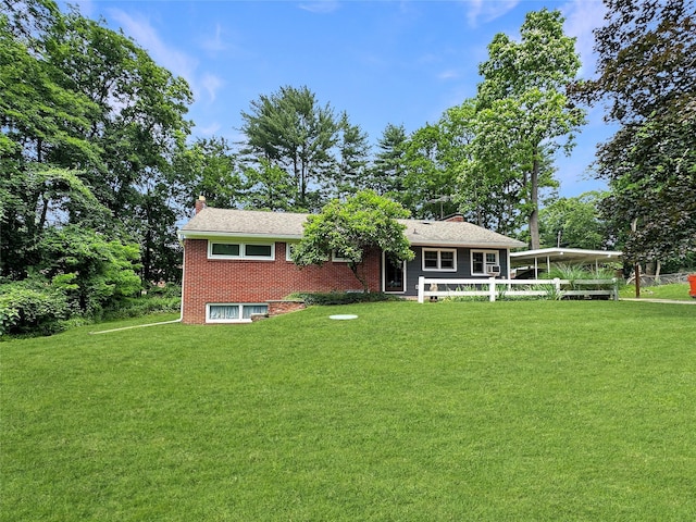 222 Beechwood Ave, Poughkeepsie, NY 12601 - view of front of home with a chimney, a front lawn, and brick siding