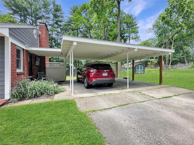 222 Beechwood Ave, Poughkeepsie, NY 12601 - view of parking featuring a storage shed, asphalt driveway, and a carport