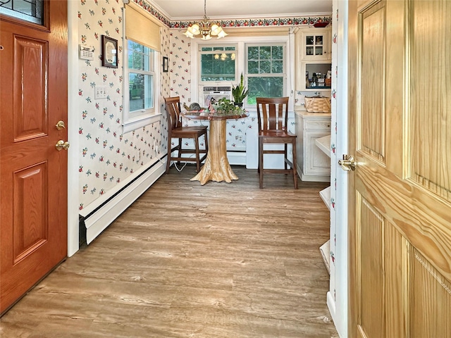 222 Beechwood Ave, Poughkeepsie, NY 12601 - entryway with baseboard heating, wallpapered walls, a chandelier, ornamental molding, and light wood finished floors
