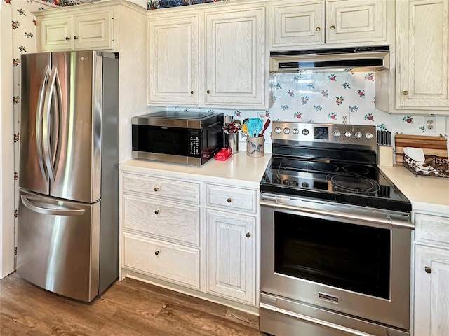 222 Beechwood Ave, Poughkeepsie, NY 12601 - kitchen featuring stainless steel appliances, range hood, light countertops, and wood finished floors