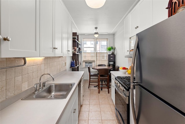 4204 64th St, Woodside, NY 11377 - kitchen featuring stainless steel appliances, decorative backsplash, white cabinetry, light countertops, and ceiling fan