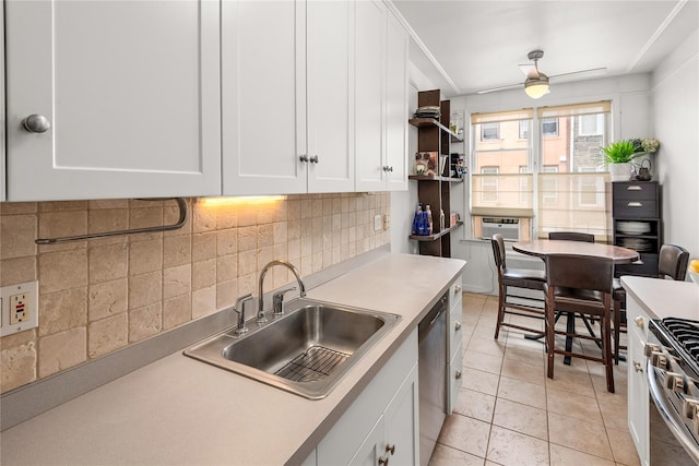 4204 64th St, Woodside, NY 11377 - kitchen featuring stainless steel appliances, white cabinets, backsplash, light countertops, and a wall unit AC