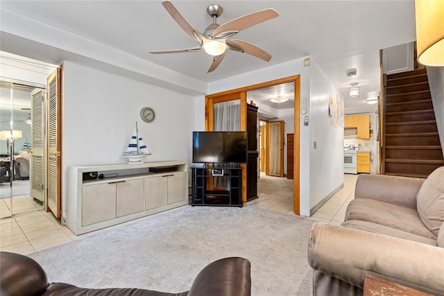 4204 64th St, Woodside, NY 11377 - living area featuring light tile patterned flooring, ceiling fan, and stairs