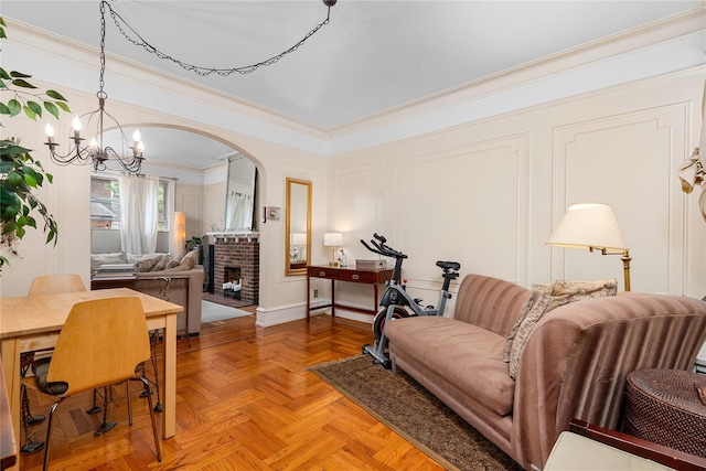 4204 64th St, Woodside, NY 11377 - living area featuring a chandelier, ornamental molding, a fireplace, and arched walkways