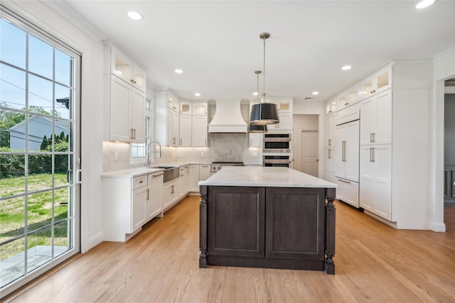 96A Calvin Ave, Syosset, NY 11791 - kitchen featuring custom exhaust hood, light wood finished floors, backsplash, white cabinets, and recessed lighting