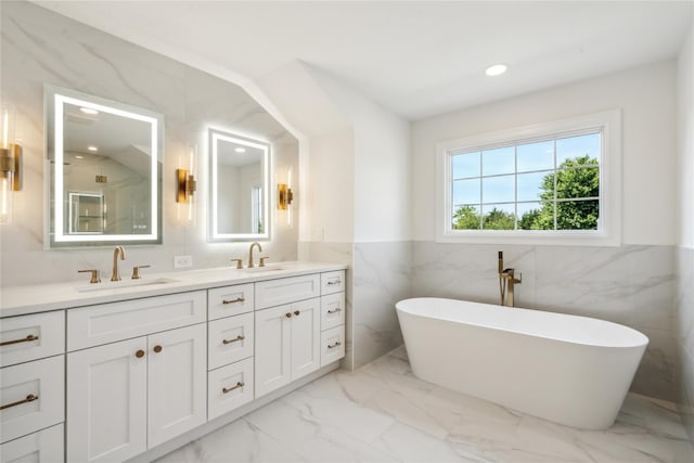 96A Calvin Ave, Syosset, NY 11791 - full bathroom featuring tile walls, marble look tiles, double vanity, a soaking tub, and recessed lighting