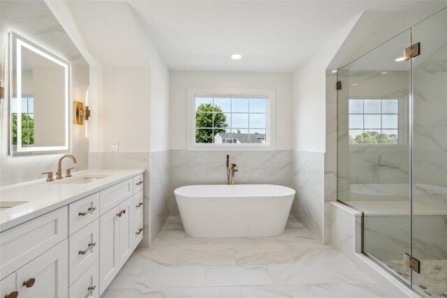 96A Calvin Ave, Syosset, NY 11791 - bathroom with double vanity, marble finish floors, a soaking tub, wainscoting, and a marble finish shower