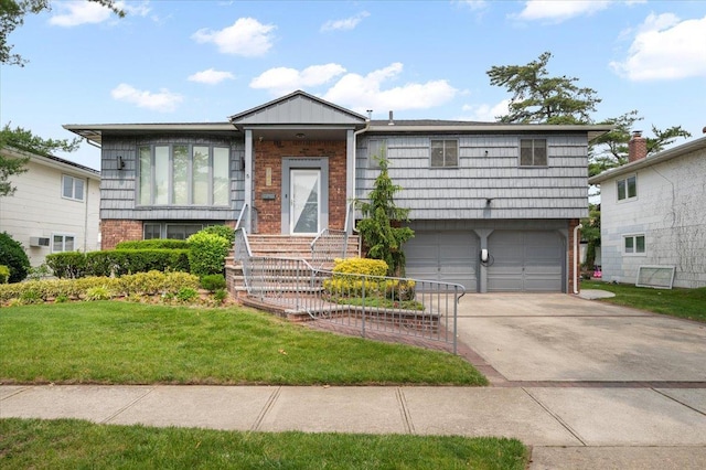 740 Eagle Dr, North Woodmere, NY 11581 - split level home with brick siding, a front lawn, concrete driveway, and a garage